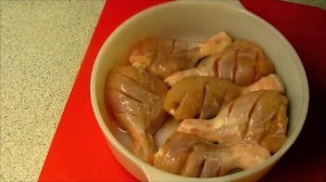 Making deep slits on either side of chicken legs