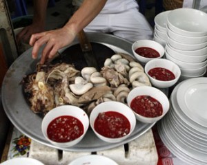 Raw blood dish is displayed with cooked entrails at a restaurant in Hanoi